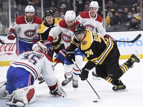 Boston Bruins left wing Jake DeBrusk (74) shoots the puck on Montreal Canadiens goaltender Sam Montembeault (35) during the third period at TD Garden on Jan. 12, 2022.