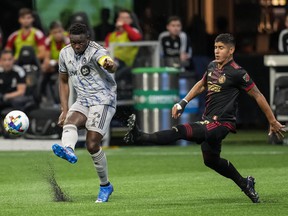 CF Montréal midfielder Victor Wanyama passes in front of Atlanta United defender Alan Franco during the first half at Mercedes-Benz Stadium in Atlanta on March 19, 2022.