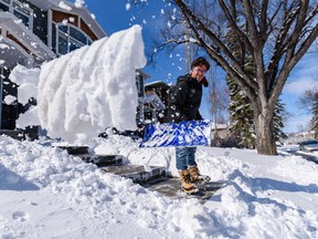 Kuwa Hara shovels Tuesday's fresh snow outside his home on Wednesday, April 20, 2022.