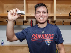 After making this NHL debut, Brady Keeper #25 of the Florida Panthers poses with the game puck after a game against the Ottawa Senators at Canadian Tire Center on March 28, 2019 in Ottawa, Ontario, Canada.