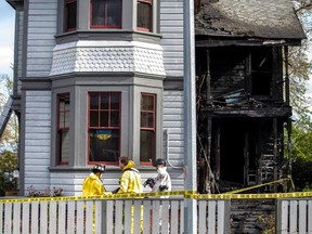 Victoria fire investigators work at a home on Caledonia Avenue that was damaged in a fire on Wednesday, April 20, 2022.
