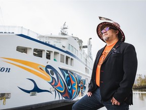 BC Ferries has unveiled its latest vessel, the Salish Heron, adorned with the art of Coast Salish artist Maynard Johnny Jr., pictured here with the vessel on April 15, 2022 in Richmond, BC