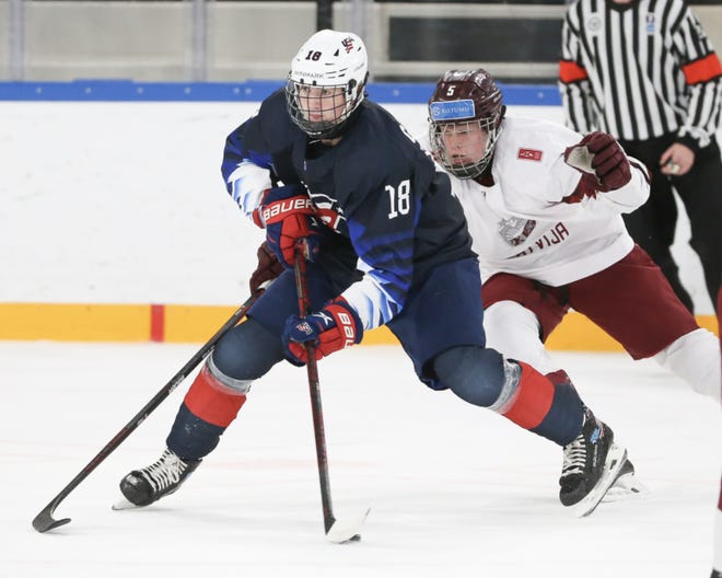 USA Hockey's Logan Cooley carries the puck during a 13-3 victory over Latvia in the quarterfinals of the U18 hockey world championship in Germany on Thursday.