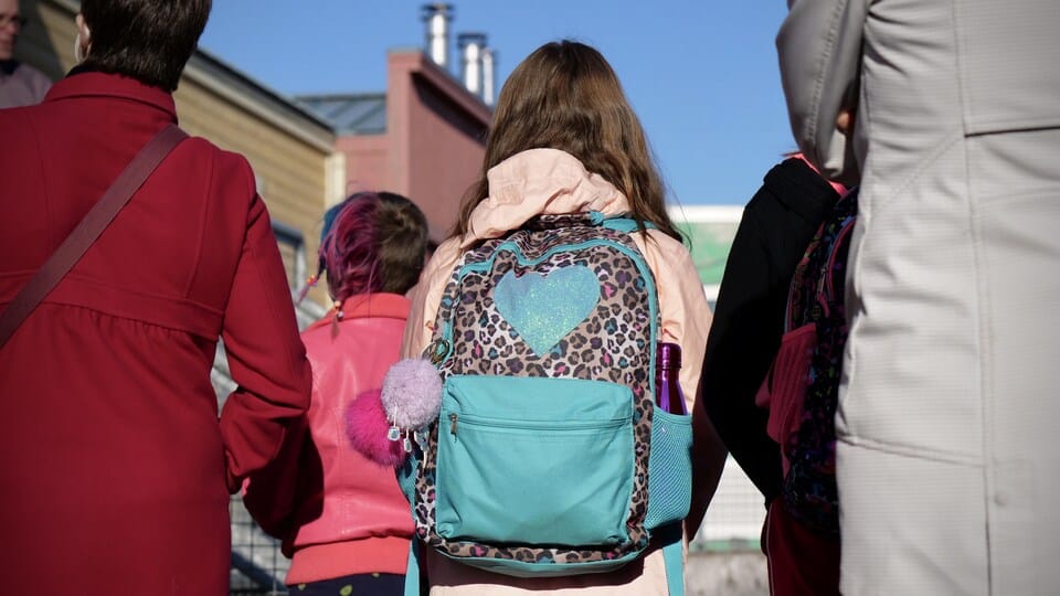 A student from the back stands in front of École des Trois-Soleils on the day of her return to school, in Iqaluit, in September 2020.