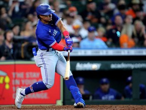 Blue Jays second baseman Santiago Espinal hits a home run to left field against the Astros during the seventh inning at Minute Maid Park in Houston, Saturday, April 23, 2022.