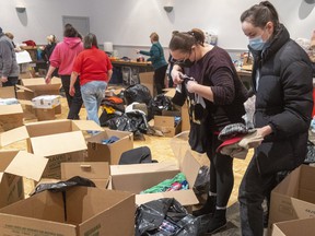 A volunteers collect, sort and box donations for the Ukrainian people at the London Ukrainian Center in London, Ont., on March 3, 2022.