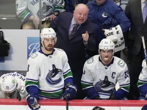 Bruce Boudreau has pushed all the right buttons to keep the Canucks in playoff contention.  He'll be counting on Conor Garland (left) to continue his fine, feisty play.