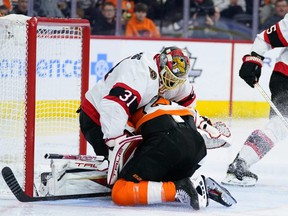 Flyers forward Scott Laughton collides with Senators goalie Anton Forsberg during the second period of Friday's game.  A Flyers goal was called back as a result of the play.  Matt Slocum/AP PHOTO