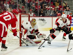 Detroit Red Wings center Oskar Sundqvist puts the puck in front of the net against Ottawa Senators goaltender Anton Forsberg and defenseman Nick Holden during the second period at Little Caesars Arena on Tuesday night.