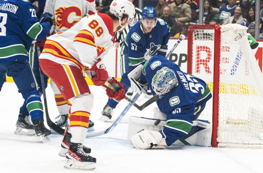 VANCOUVER, BC - MARCH 19: Goalie Thatcher Demko #35 of the Vancouver Canucks makes a save on a close shot by Andrew Mangiapane #88 of the Calgary Flames during the first period in NHL action on March 19, 2022 at Rogers Arena in Vancouver, British Columbia, Canada.  (Photo by Rich Lam/Getty Images)
