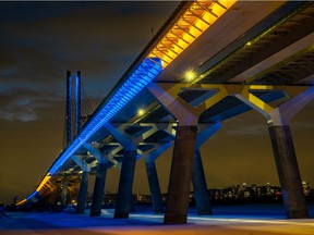 The Champlain Bridge was lit up in blue and yellow in Brossard on Saturday, Feb. 26, 2022 in support of the conflict in Ukraine.