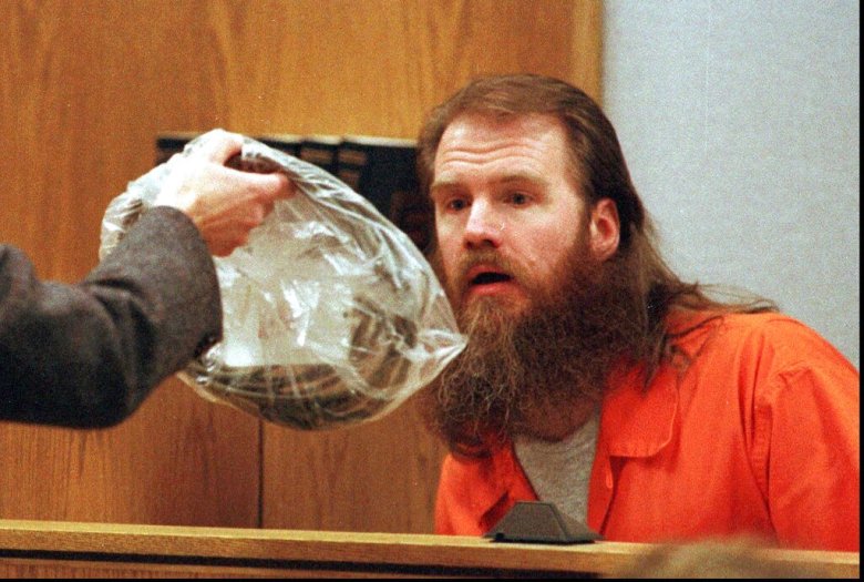 Dan Lafferty, convicted brother of defendant Ronald Lafferty, looks at evidence Tuesday, April 2, 1996, during testimony in the retrial for the 1984 murders of Brenda and Erica Lafferty in Provo, Utah. The evidence seen is a vacuum cord that was tied around Brenda Lafferty's neck. (AP Photo/Stuart W. Johnson, pool)