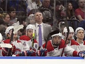 Canadiens interim head coach Martin St. Louis checks a replay during the first period against the Tampa Bay Lightning on Saturday, April 2, 2022, in Tampa.