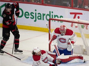 Montreal Canadiens goalie Carey Prices (31) makes a save as Ottawa Senators right wing Drake Batherson (19) looks on in the third period at the Canadian Tire Center on April 23, 2022.
