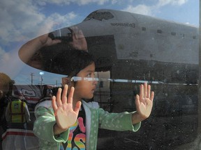 A child gazes at the Space Shuttle Endeavor on its final journey in 2012. Children can easily see through mindless jibber-jabber questions adults ask, Hayley Juhl writes.