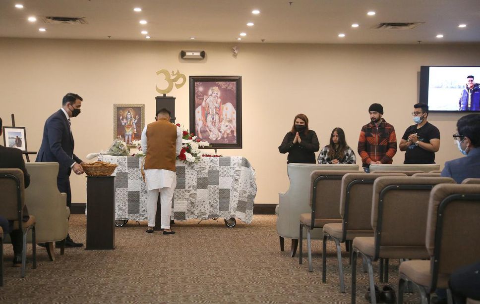 Mourners gather at the visitation for Kartik Vasudev on Wednesday.