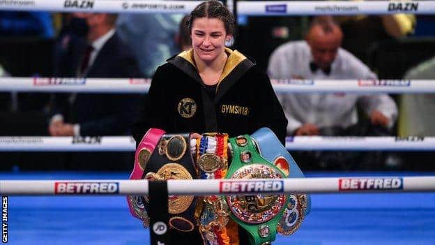 Katie Taylor poses for pictures with her world titles
