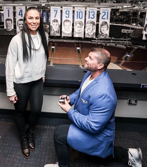 Maple Leafs superfan Mark Fera (right) gets on a bent knee to propose to his girlfriend, Rita Marini, at the Scotiabank Arena Tuesday.  (Dan Bodanis/Special to the Sun)
