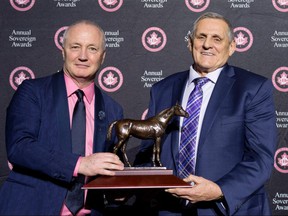 Jockey Club of Canada Chief Steward Glenn Sikura (left) and Mighty Heart owner Larry Cordes pose with a Sovereign Award.  Mighty Heart was named the 2021 Horse of the Year on April 14, 2022 in Woodbridge, Ont.