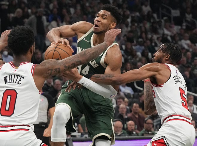 Bucks forward Giannis Antetokounmpo is fouled by Bulls forward Derrick Jones Jr. during the first half Wednesday night at the Fiserv Forum.