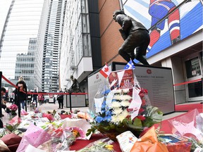 Flowers and objects at the base of the statue of Guy Lafleur before the game between the Boston Bruins and the Montreal Canadiens at the Bell Center on April 24, 2022.