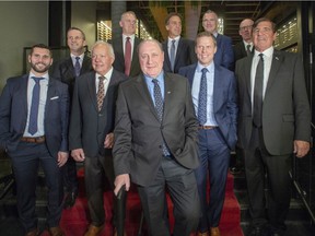 Former captains of the Montreal Canadiens pose for pre-game photos on the 110th anniversary of the team's founding in Montreal, on Dec. 3, 2019. Front row, from left: Brian Gionta, Yvan Cournoyer, Bob Gainey, Saku Koivu and Serge Savard .  Back row, from left: Guy Carbonneau, Vincent Damphousse, Chris Chelios, Pierre Turgeon and Mike Keane.