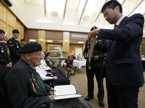 Kangjun Lee from the Consulate General of the Republic of Korea in Vancouver, presents Austin McClure (left) with an Ambassador For Peace Medal at the Kipnes Center for Veterans in Edmonton on Thursday, June 1, 2017. Ian Kucerak / Postmedia