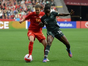 Canadian forward Christine Sinclair (12) challenges Women's Nigeria National Christy Onyenaturuchi Ucheibe (14) during the first half at BC Place on April 8, 2022. The two teams faced each other again in Langford, BC, playing to a 2-2 tie on April 11, 2022.