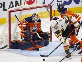 Edmonton Oilers goalie Mike Smith (41) watches as Vegas Golden Knights Mark Stone (61) battles for the puck with Darnell Nurse (25) during first period NHL action on Saturday, April 16, 2022 in Edmonton.  Greg Southam - Postmedia