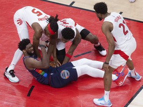 Raptors' Precious Achiuwa, OG Anunoby and Thad Young gang up on Sixers star Joel Embiid during yesterday's 110-102 Game 4 victory at Scotiabank Arena.