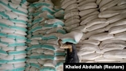A worker carries a sack of wheat flour at a World Food Program food aid distribution center in Sanaa, Yemen, on Feb. 11, 2020. (Khaled Abdullah/Reuters)