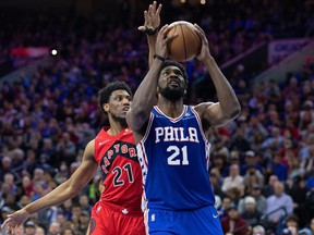 Apr 25, 2022;  Philadelphia, Pennsylvania, USA;  Philadelphia 76ers center Joel Embiid moves to the basket ahead of Toronto Raptors forward Thaddeus Young during the fourth quarter in game five of the first round for the 2022 NBA playoffs at Wells Fargo Center.