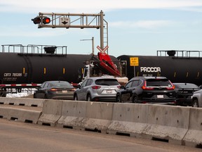 Traffic backs up as a Canadian Pacific train pulls into the yard at 50 Street south of 82 Avenue in Edmonton on Monday, April 4, 2022. The area is the location of a CP grade separation project by the City of Edmonton.