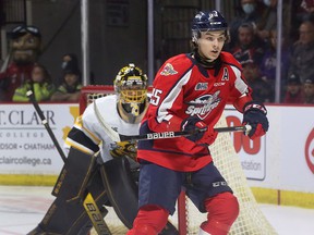 Windsor Spitfires' center Wyatt Johnston looks for the puck near Sarnia Sting goalie Ben Gaudreau.  Johnston had three assists as the Spitfires took a 2-0 series lead with a 4-1 victory at the WFCU Centre.