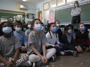 Students at St. Monica Elementary School listen to a book reading in January.  Throughout the pandemic, Quebec has maintained schools do not drive transmission but are rather a reflection of the situation in the province.  But a professor who has studied transmission in schools during previous waves says the government's continued stance is misguided.