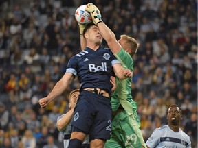 Sporting Kansas City keeper Tim Melia catches the ball over Vancouver Whitecaps striker Brian White in a Round 1 MLS playoff game at Children's Mercy Park.  White will return to the lineup from injury on Saturday.