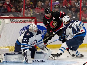 Winnipeg Jets defenseman Josh Morrissey (44) battles with Ottawa Senators right wing Connor Brown (28) in the second period at the Canadian Tire Center.