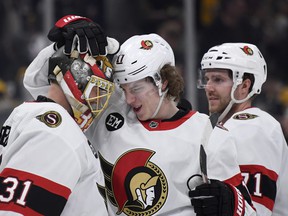 Ottawa Senators center Adam Gaudette (17) congratulates goaltender Anton Forsberg (31) after defeating the Boston Bruins at TD Garden.