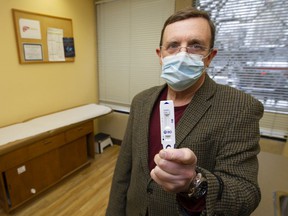 Dr. Brian Conway with a rapid test kit.