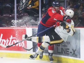 WINDSOR, ON.  APRIL 21, 2022-Matthew Maggio, left, of the Windsor Spitfires knocks Alexis Daviault of the Sarnia Sting off his feet on Thursday, April 21, 2022 at the WFCU Center in Windsor.