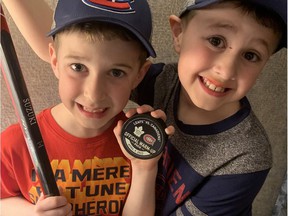 Young Habs fans Hunter Beauparlant, left, and brother Jaxen with a stick and puck given to Hunter by Canadiens center Nick Suzuki before a game against the Maple Leafs in Toronto on April 9, 2022.