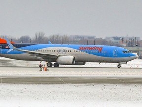 A Sunwing Boeing 737 aircraft taxis before taking off from Trudeau Airport in Montreal Thursday January 6, 2022.