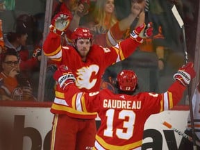 Calgary Flames forward Elias Lindholm celebrates a goal against the Edmonton Oilers with Johnny Gaudreau at the Scotiabank Saddledome on Saturday, March 26, 2022.