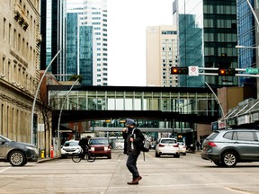 A pedestrian makes their way through downtown Edmonton, on Tuesday March 1, 2022.