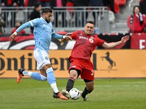 Toronto FC defender Shane O'Neill battles for the ball with New York City FC forward Valentin Castellanos.