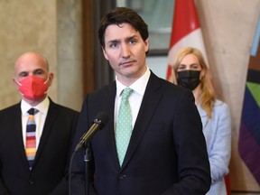 Prime Minister Justin Trudeau stands with Minister of Tourism Randy Boissonnault and and Minister of Sport Pascale St-Onge during an announcement on the ending of the Canadian Blood Services' blood ban, in Ottawa, on Thursday, April 28, 2022.