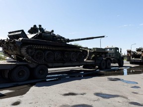 Captured Russian tanks are carried on platforms by the Ukrainian army on a road outside Dnipro, Ukraine, Saturday, April 30, 2022.