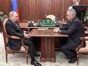 This handout photo released by the Russian Presidential Press Office on Thursday, April 21, 2022 shows Russian President Vladimir Putin (left) speaking with Russian Defense Minister Sergei Shoigu during their meeting at the Kremlin in Moscow.