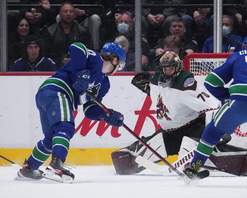Vancouver Canucks' Vasily Podkolzin, left, scores against Arizona Coyotes goaltender Karel Vejmelka during second period NHL action in Vancouver on Thursday, April 14, 2022.