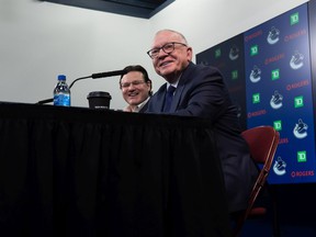 File photo: Canucks President and Interim General Manager Jim Rutherford, front, and Canucks owner Francesco Aquilini are all smiles at their first news conference together on Dec. 13, 2021 in Vancouver.
